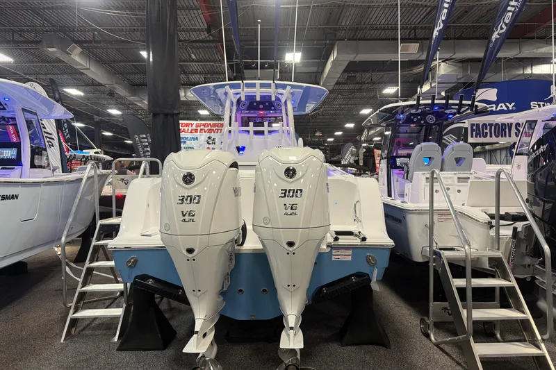 Slide: The Image of 2026 Sportsman Open 302 Center Console boat with twin 300 V6 engines at a boat show. - 1