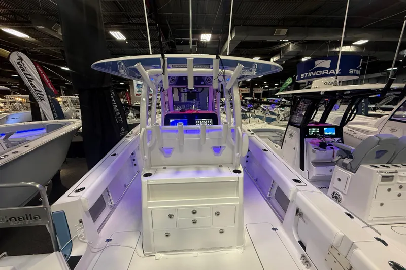 Slide: The Image of 2026 Sportsman Open 302 Center Console boat interior at a showroom display. - 11