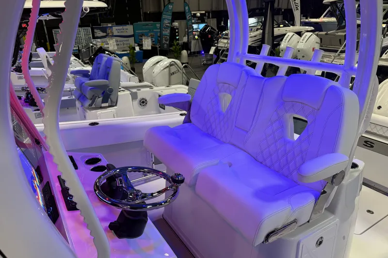 Slide: The Image of 2026 Sportsman Open 302 Center Console with illuminated seating and modern steering wheel. - 12
