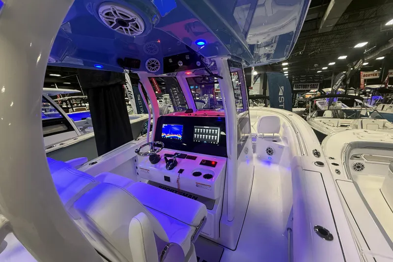 Slide: The Image of 2026 Sportsman Open 302 Center Console boat interior with illuminated dashboard and seating. - 3