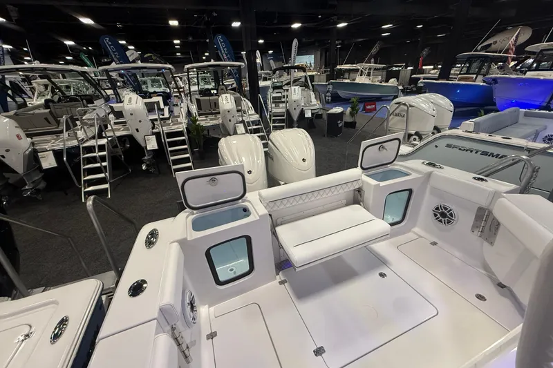 Slide: The Image of 2026 Sportsman Open 302 Center Console at a boat show, showcasing sleek design and features. - 9