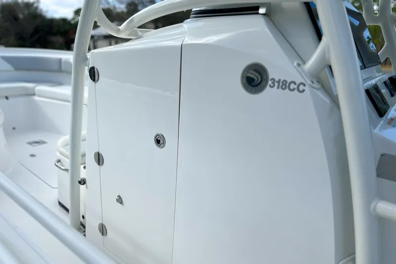 Slide: The Image of 2011 Edgewater 318CC boat console with sleek white design and secure storage. - 12