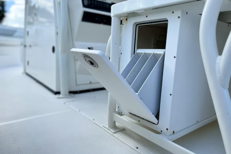 Slide: The Image of Open storage compartment on 2011 Edgewater 318CC boat, showcasing interior dividers. - 13