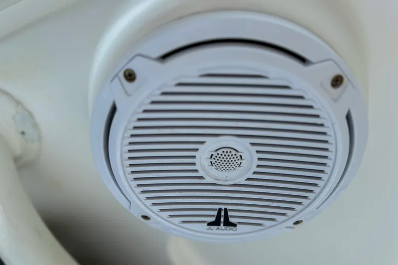 Slide: The Image of White JL Audio speaker on 2011 Edgewater 318CC boat interior. - 16