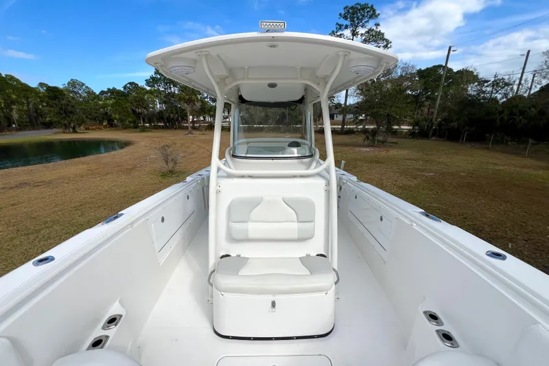 Slide: The Image of 2011 Edgewater 318CC boat interior with seating, white finish, and open deck. - 18