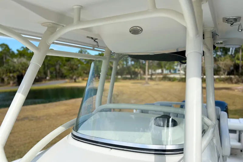 Slide: The Image of 2011 Edgewater 318CC boat windshield and canopy, with scenic background. - 19