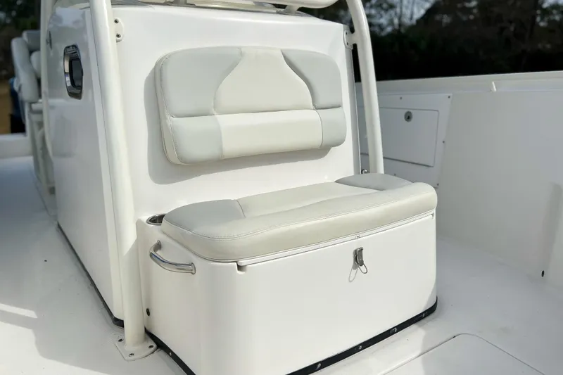 Slide: The Image of 2011 Edgewater 318CC boat interior with cushioned seating and storage compartment. - 20