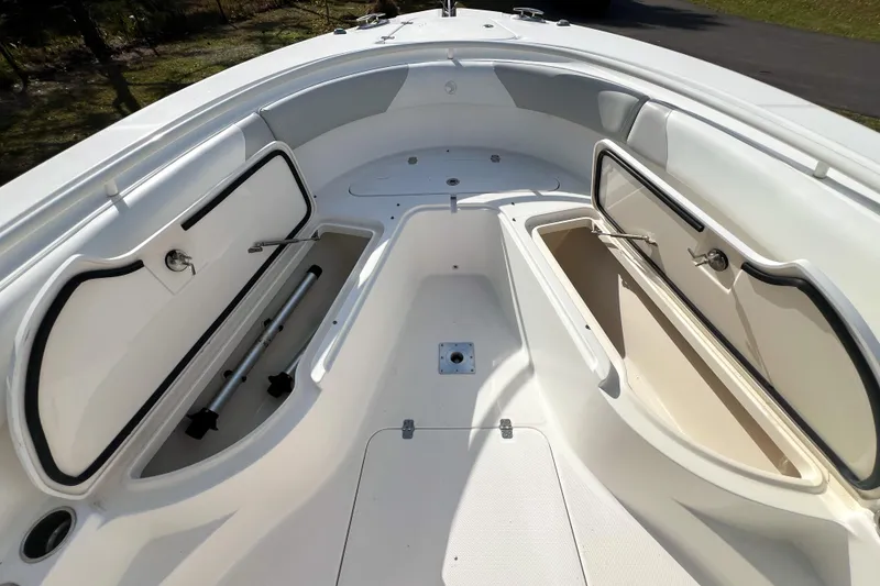 Slide: The Image of 2011 Edgewater 318CC boat interior with open storage compartments. - 24