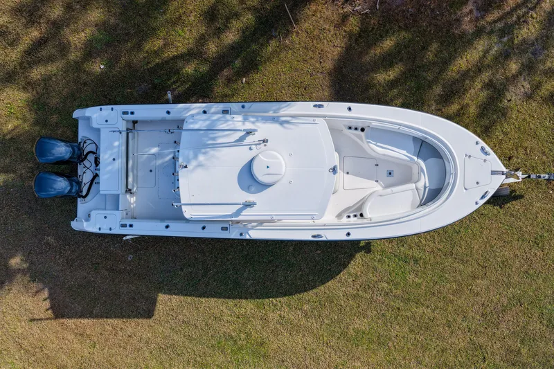 Slide: The Image of Aerial view of 2011 Edgewater 318CC boat on grass, showcasing dual engines. - 27