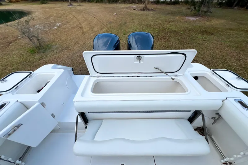Slide: The Image of 2011 Edgewater 318CC boat with open storage compartments and dual engines, viewed from above. - 4