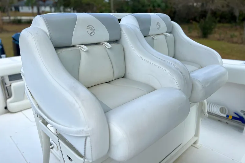Slide: The Image of White leather seats on a 2011 Edgewater 318CC boat, showcasing comfort and style. - 7