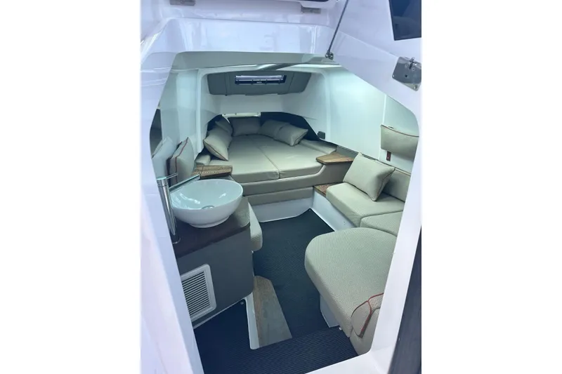 Slide: The Image of 2021 Axopar 37 Sun-Top cabin interior with cozy seating and modern design. - 13