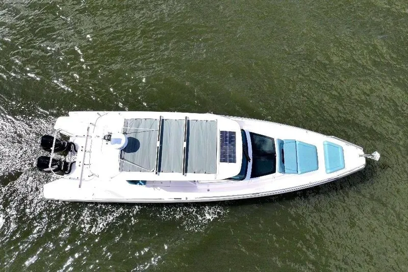 Slide: The Image of Aerial view of 2022 Axopar 37 Sun-Top boat cruising on water. - 6