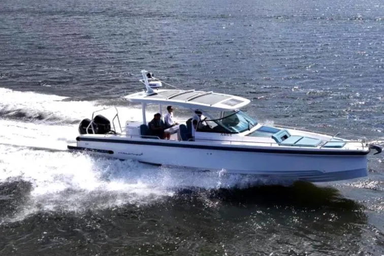Slide: The Image of 2021 Axopar 37 Sun-Top cruising on open water with passengers onboard. - 7