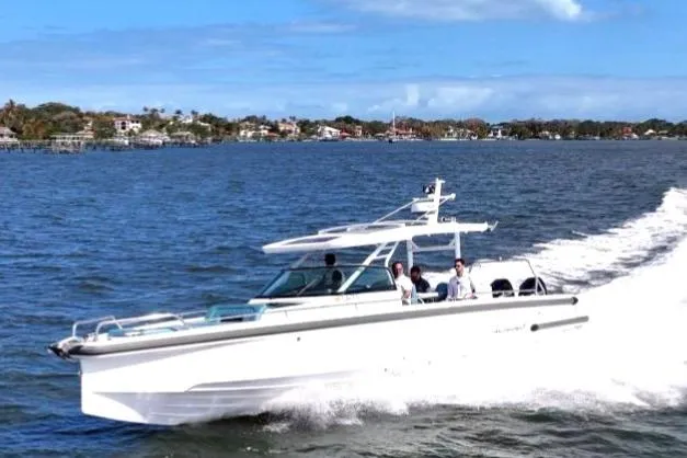 Slide: The Image of 2021 Axopar 37 Sun-Top cruising on a sunny day, with passengers enjoying the ride. - 8