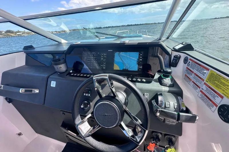 Slide: The Image of 2021 Axopar 37 Sun-Top boat dashboard with navigation display and controls. - 9