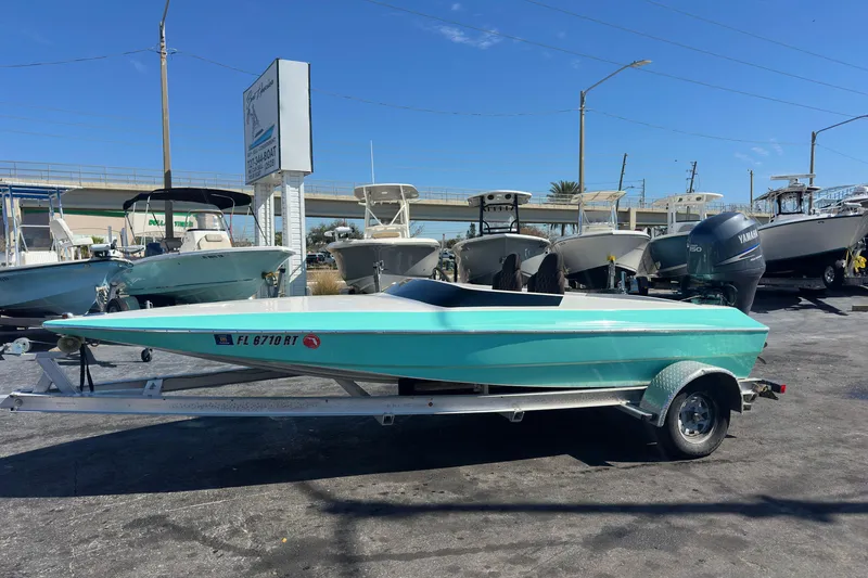 Slide: The Image of 2022 Lightning 18 boat with Yamaha engine on trailer, displayed at dealership. - 0