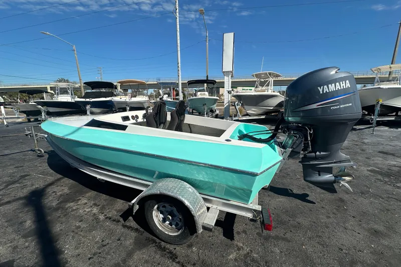 Slide: The Image of 2022 Lightning 18 boat with Yamaha engine on trailer, parked in marina. - 1