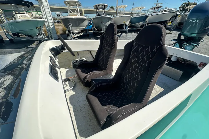 Slide: The Image of 2022 Lightning 18 boat interior with two black seats and steering wheel. - 12