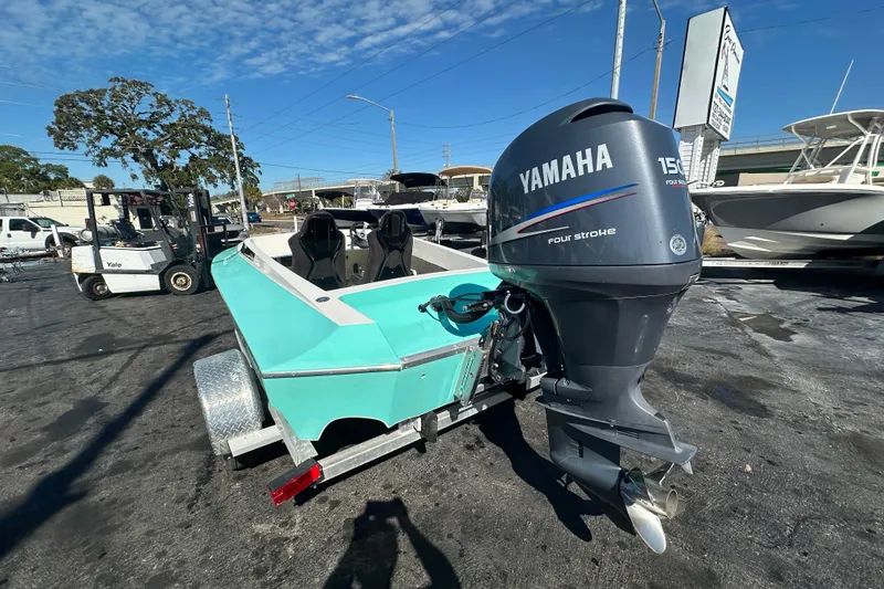 Slide: The Image of 2022 Lightning 18 boat with Yamaha 150 outboard motor in a marina setting. - 2