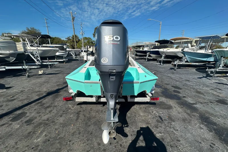 Slide: The Image of 2022 Lightning 18 boat with 150 horsepower engine in a marina setting. - 3