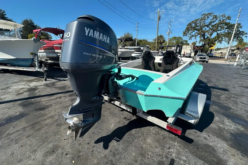 Slide: The Image of Turquoise Lightning 18 boat with Yamaha outboard motor on a trailer, 2022 model. - 4
