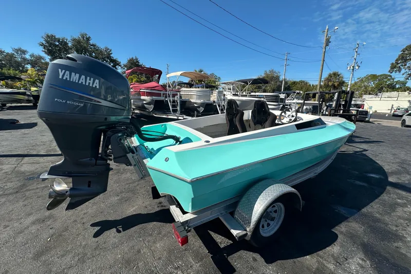 Slide: The Image of 2022 Lightning 18 boat with Yamaha four-stroke engine, parked on a trailer. - 5