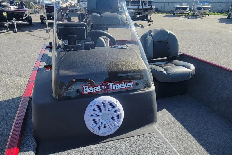 Slide: The Image of 2024 Tracker Bass Tracker Classic XL boat interior with steering console and seating. - 13