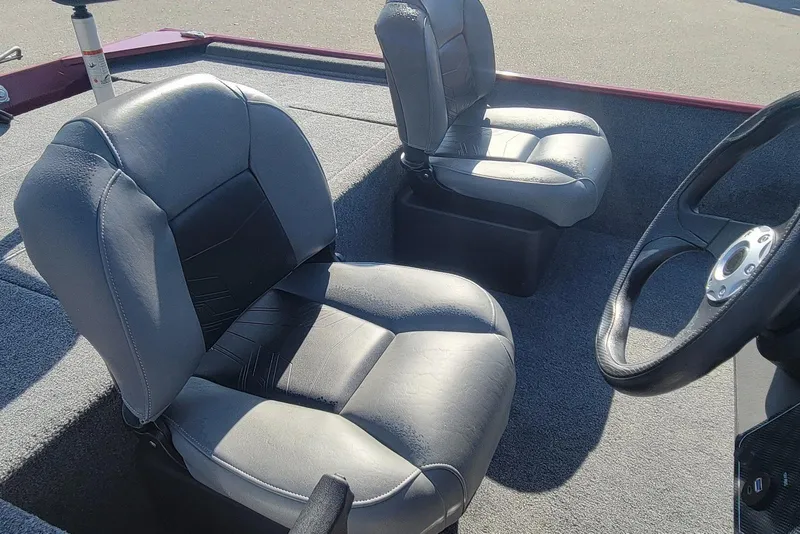 Slide: The Image of 2024 Tracker Bass Tracker Classic XL boat interior with two gray seats and steering wheel. - 14