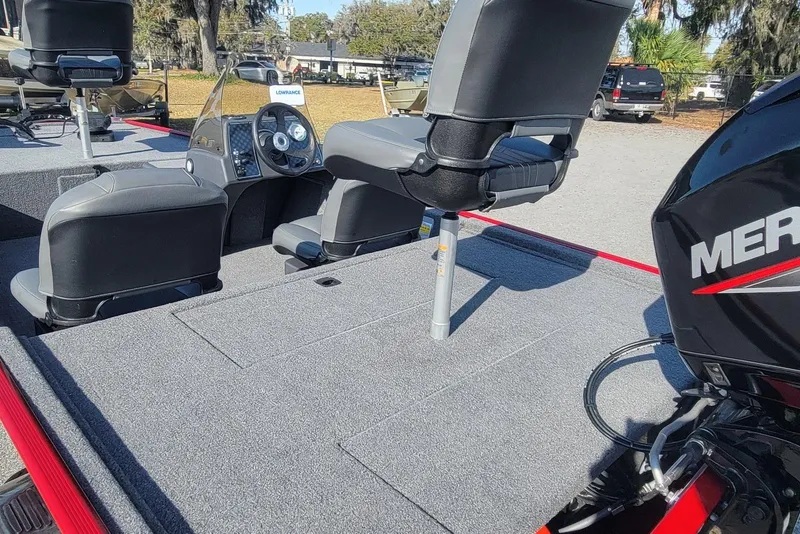 Slide: The Image of 2024 Tracker Bass Tracker Classic XL boat interior with seats and Mercury engine. - 8