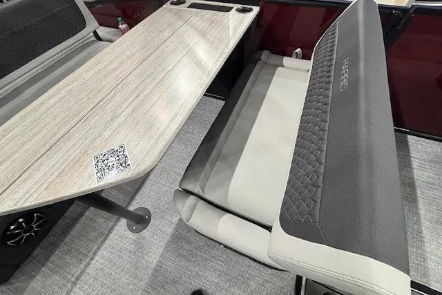 Slide: The Image of 2026 Harris Sunliner 230 interior with modern seating and table, featuring a QR code. - 10
