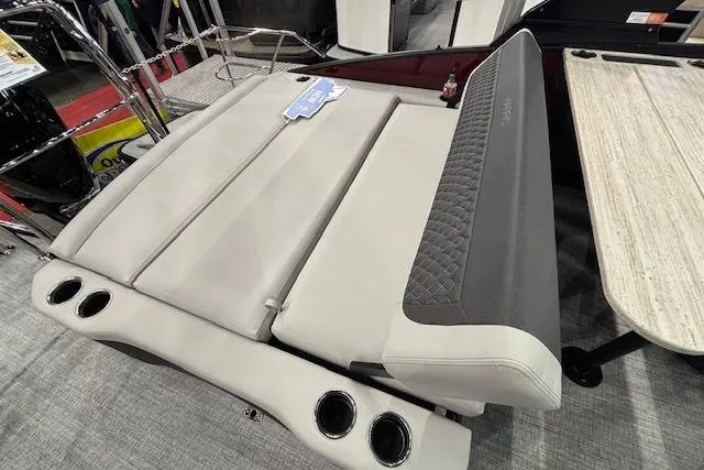 Slide: The Image of 2026 Harris Sunliner 230 boat interior with plush seating and cup holders. - 13