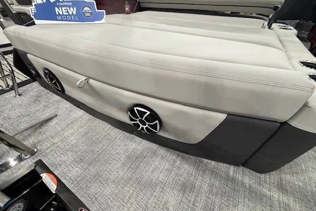 Slide: The Image of 2026 Harris Sunliner 230 boat interior with sleek seating and built-in speakers. - 15