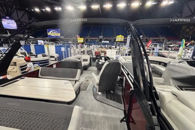 Slide: The Image of 2026 Harris Sunliner 230 pontoon boat interior at a boat show display. - 18