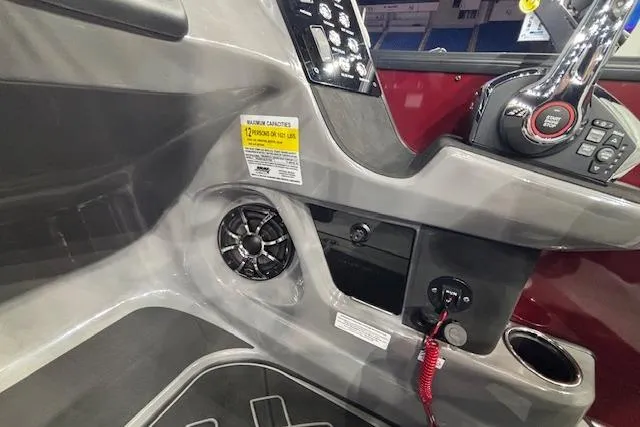 Slide: The Image of Interior view of 2026 Harris Sunliner 230 boat dashboard with controls and speaker. - 21