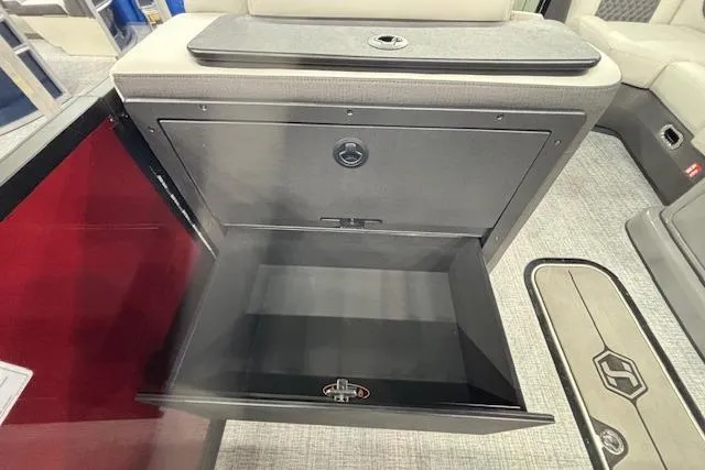 Slide: The Image of 2026 Harris Sunliner 230 storage compartment with open door, showcasing interior space. - 29