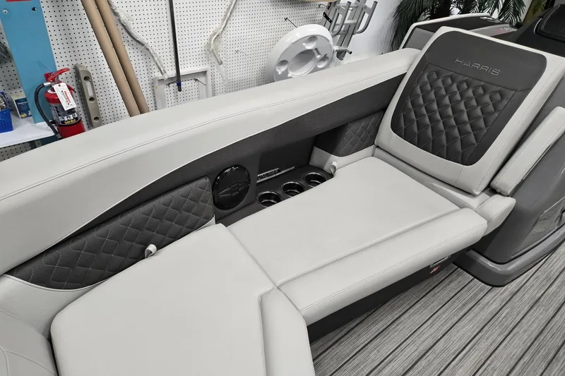 Slide: The Image of 2026 Harris Sunliner 230 boat interior with luxurious seating and cup holders. - 10