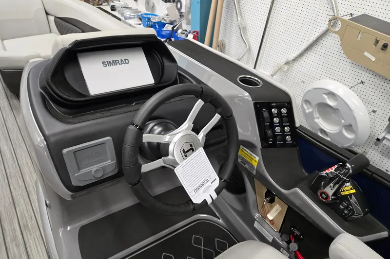 Slide: The Image of 2026 Harris Sunliner 230 boat dashboard with Simrad display and steering wheel. - 15