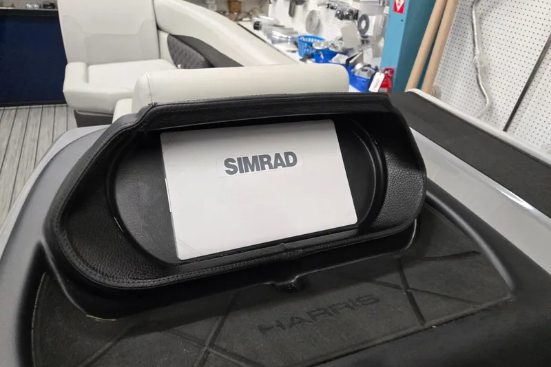 Slide: The Image of 2026 Harris Sunliner 230 boat dashboard featuring a Simrad display. - 16