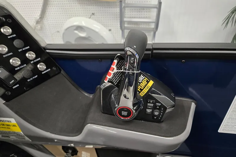 Slide: The Image of Control panel of 2026 Harris Sunliner 230 boat with throttle and switches. - 20