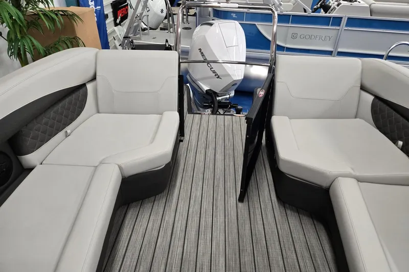Slide: The Image of 2026 Harris Sunliner 230 interior with plush seating and Mercury outboard motor. - 21