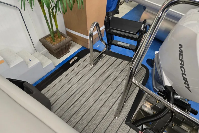 Slide: The Image of 2026 Harris Sunliner 230 boat deck with Mercury engine and stainless steel ladder. - 25