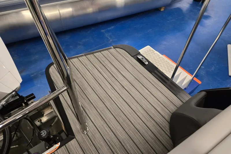 Slide: The Image of 2026 Harris Sunliner 230 boat interior with striped flooring and metal railings. - 26