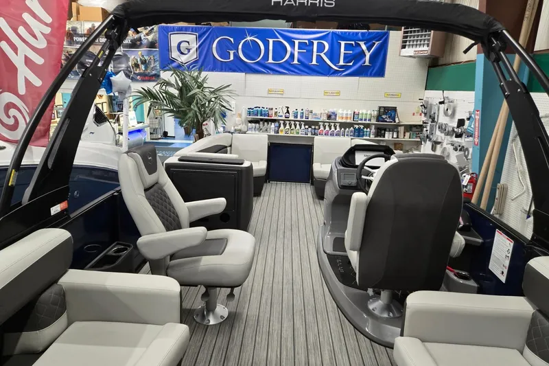 Slide: The Image of 2026 Harris Sunliner 230 boat interior with luxurious seating and modern dashboard. - 27