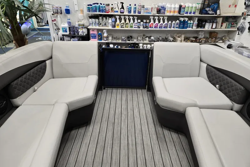 Slide: The Image of 2026 Harris Sunliner 230 interior with luxurious seating and marine supplies display. - 32