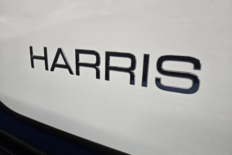 Slide: The Image of Close-up of "Harris" logo on 2026 Sunliner 230 boat exterior. - 35