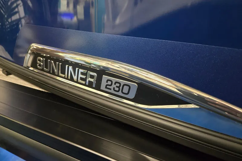 Slide: The Image of 2026 Harris Sunliner 230 logo on sleek blue surface. - 37