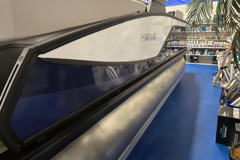 Slide: The Image of 2026 Harris Sunliner 230 pontoon boat displayed indoors, showcasing sleek design and modern features. - 6