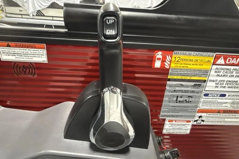 Slide: The Image of Throttle control lever on a 2026 Bennington 22 SSBSF boat with capacity warnings. - 13