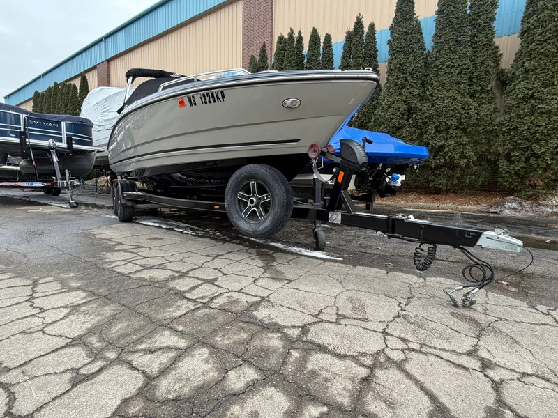Slide: The Image of 2019 Monterey 224FS boat on trailer outside warehouse. - 15
